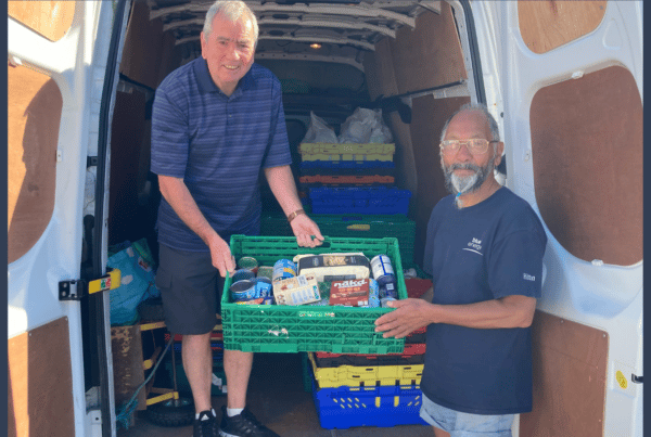 two men oad a van with food supplies